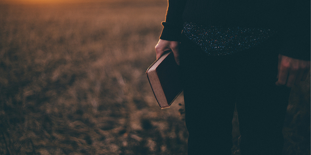Image of a person holding a Bible
