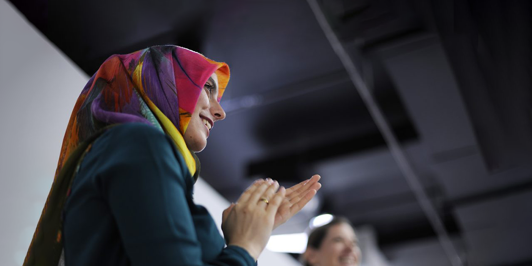 Young woman smiling and clapping
