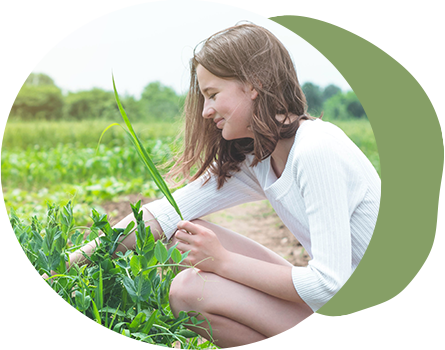 Image of a girl picking a plant