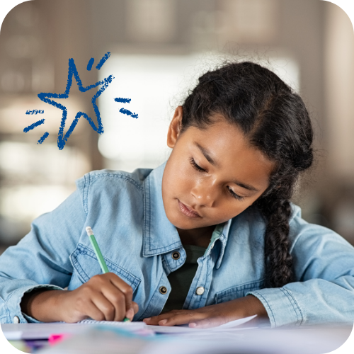 Student writing at her desk