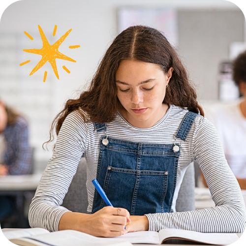 Student writing at her desk