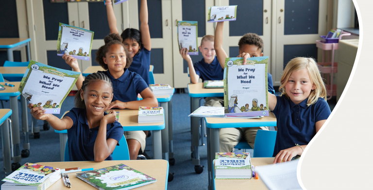 Kids in a classroom excitedly holding up Discover! worksheets